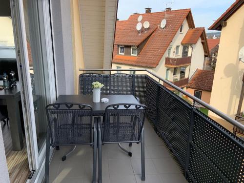 a balcony with a table and chairs on a balcony at BestBoarding24 in Schöllkrippen