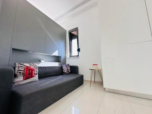 a living room with a black couch in a room at Riviera Studios in Mamaia