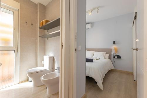 a bedroom with a bed and a toilet and a sink at Charming 2 Bedroom Apartment at Rodrigo de Triana By Oui Seville in Seville