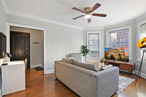 a living room with a couch and a ceiling fan at 1BR Homey Apt in Irving Park - Troy 2 in Chicago