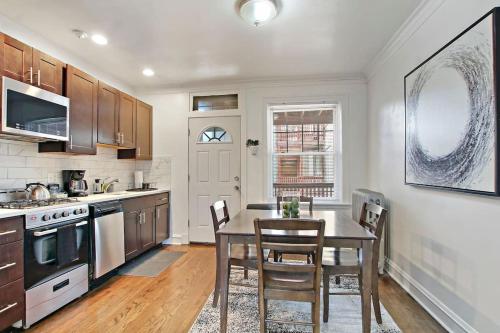 a kitchen with a table and chairs in a room at 1BR Homey Apt in Irving Park - Troy 2 in Chicago