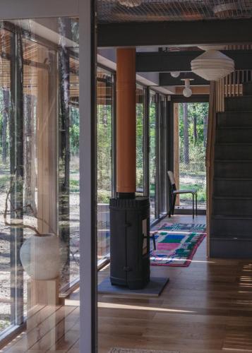 a living room with a wood stove in a house at HATTA Las in Gąsiorowo Duże