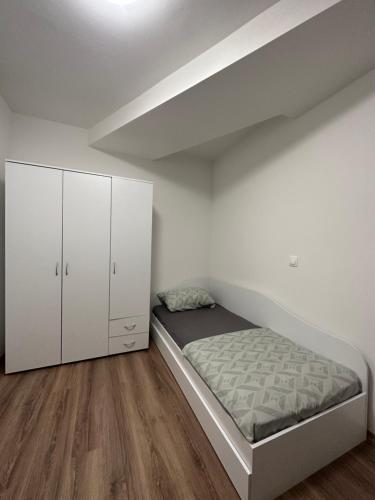 a bedroom with a bed and a white cabinet at Velvet Vista in Štip