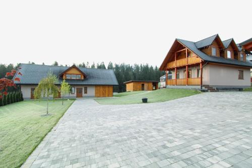 a house with a brick driveway in front of a house at Котедж "Валерія" in Vorokhta