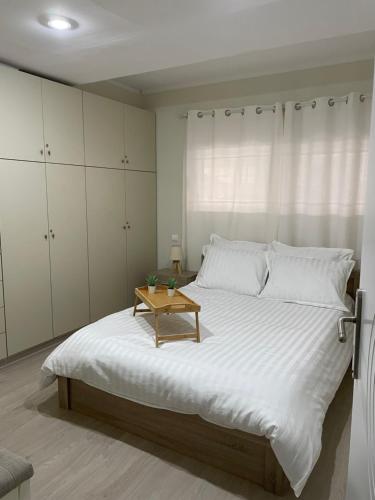 a bedroom with a large bed with a table on it at Triptolemus Stay Inn in Eleusis