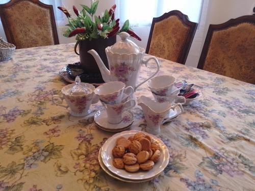 a table with a teapot and cups and cookies on it at Altos del Maria -mountaine views in Sorá