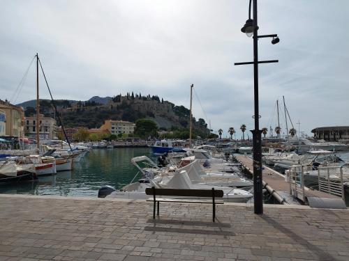 a bench sitting next to a marina with boats at Sweet Calanque - Host Provence in Cassis
