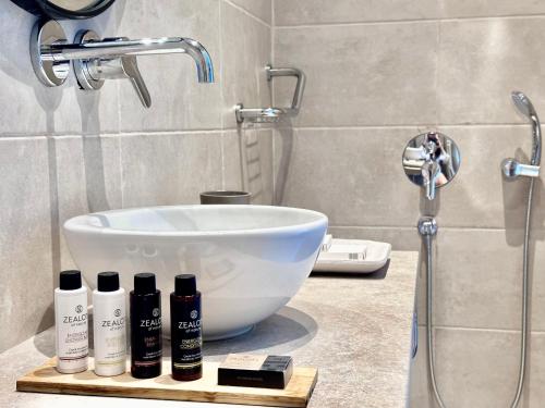 a bathroom with a white sink and a shower at Topos luxury stay Heraion in Loutraki