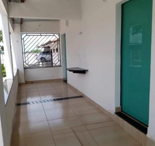 an empty room with a large window and a hallway at Pousada da Rotatória in São Gonçalo do Amarante