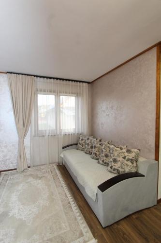a bedroom with a bed and a large window at Котедж "Валерія" in Vorokhta