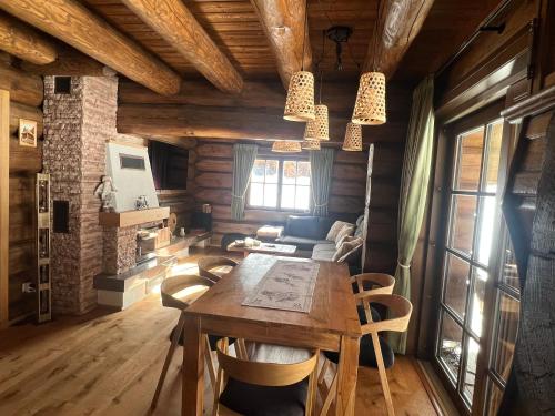 a dining room with a wooden table and chairs at Cabin House Čičmany- Relaxačné zariadenie s ubytovaním in Čičmany