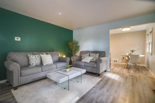 a living room with two couches and a table at Cozy Minneapolis Duplex - 10 Mi to Downtown! in Minneapolis