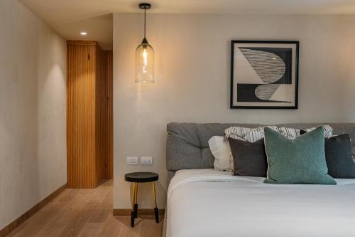 a bedroom with a bed and a pendant light at Le Cottage San Miguel de Allende, Modern Luxury in Centro with Pool & Jacuzzi in San Miguel de Allende