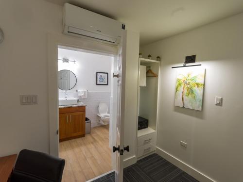 a bathroom with a toilet and a sink at Grand Coastal Hotel in Georgetown