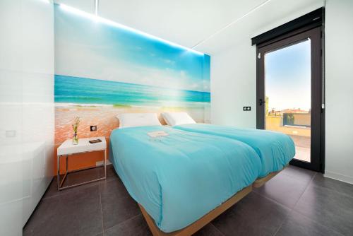 a bedroom with a bed with a painting on the wall at Blue Star Meloneras Villa in San Bartolomé de Tirajana