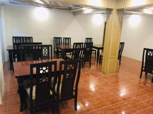 a group of tables and chairs in a room at Skardu Lodge in Skardu