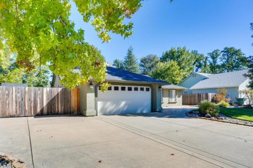 a house with a fence and a white garage at Redding Home with Patio Near Fishing! in Redding