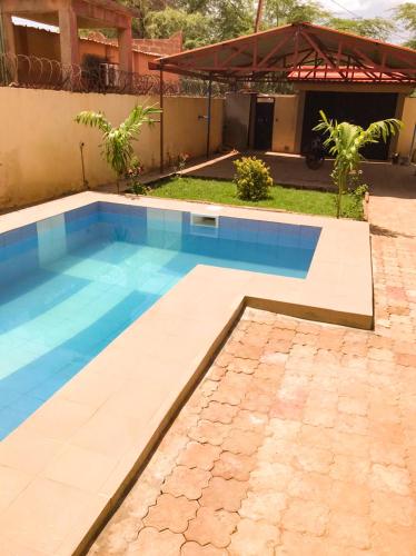 a swimming pool in the backyard of a house at Résidences KZOTOOL Ouaga in Ouagadougou