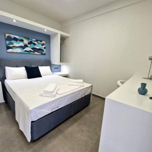 a bedroom with a large bed in a room at Farisma - Bright and central apt in Kalamata in Kalamata