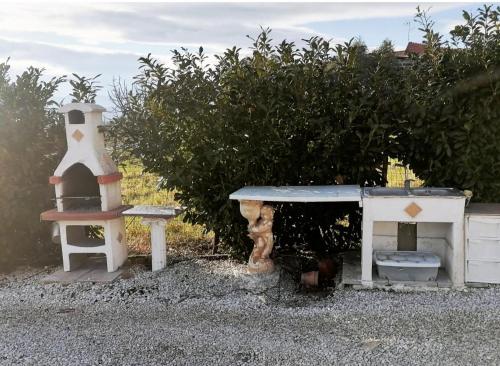 a play area with a table and a bench and a stove at Casa vacanza “oasi” in Salerno