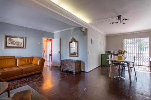 a living room with a couch and a table at MàHouse GuestHouse in Lisbon