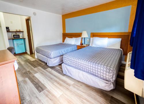 Ένα ή περισσότερα κρεβάτια σε δωμάτιο στο Budget Inn