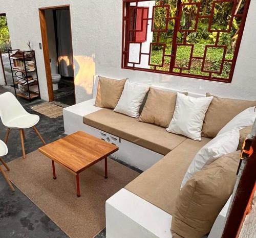 a living room with a couch and a table at Casa Bolita in Dos Brazos