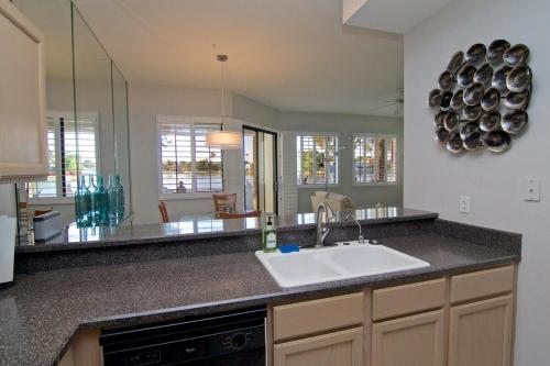 a kitchen with a sink and a counter top at Waterfront Views, Office, Main Floor, Walkable in Scottsdale