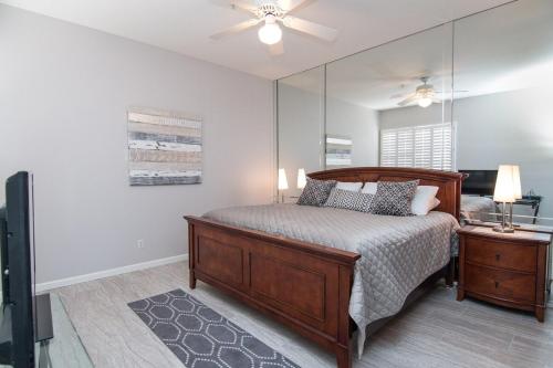 a bedroom with a bed and a large mirror at Waterfront Views, Office, Main Floor, Walkable in Scottsdale