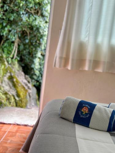 a couch with a pillow sitting on top of it at BUNGALOWS ANDREA in Tepoztlán