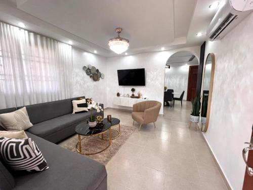 a living room with a couch and a table at Vacation Family Home 5 min from STI Airport WiFi-AC-Netflix 