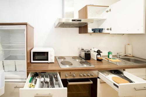 a small kitchen with a sink and a microwave at Premium 80 m2 Rooftop Apartment - 5 min to Center in Vienna