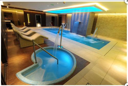 a hotel room with a jacuzzi tub in the lobby at Millhouse Cottage A Luxury 3 bed Bungalow in Antrim