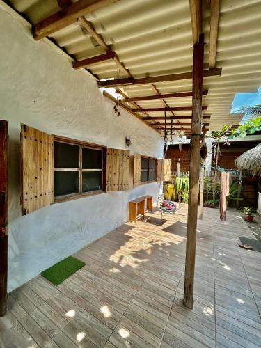 an outdoor patio with awning and a table at The Sea Garden House in Olón