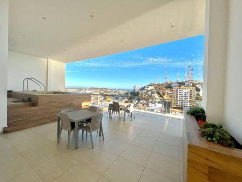 a dining room with a view of a city at Boca de cielo 504 / Vista al mar in Mazatlán