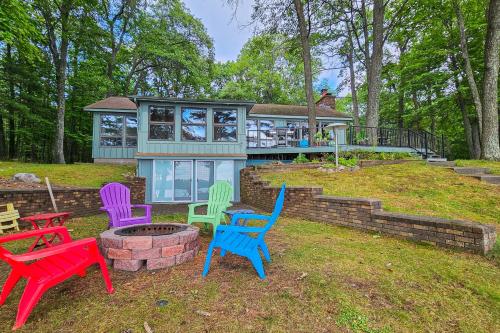 a group of colorful chairs in front of a house at Artist's Cove in Manitowish Waters