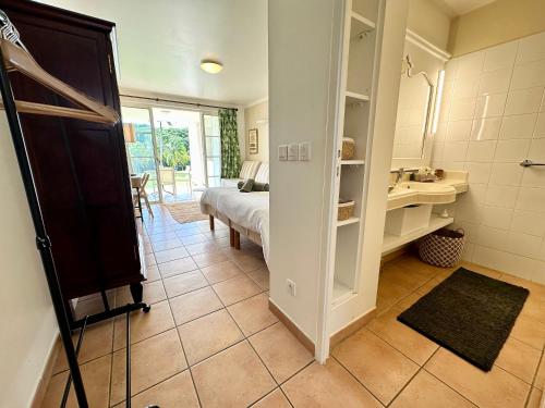 a bathroom with a bed and a sink in a room at Studio dans un magnifique complexe de vacances a ST luce in Sainte-Luce
