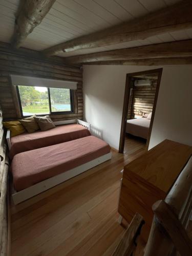 a bedroom with a large bed and a mirror at Ventanas al Norte in Chascomús