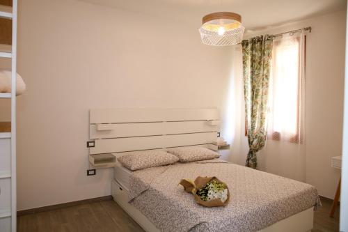 a white bedroom with a bed and a window at B&B Zvana's - Da Giovanna in Imola