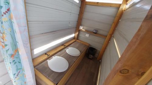 an inside view of a tiny house with two toilets at Painted Desert Wellness Retreat in Pinta