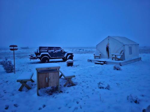 a jeep and a tent in a snowy field at Painted Desert Wellness Retreat in Pinta