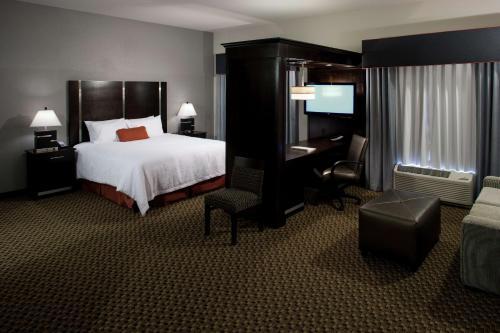 a hotel room with a bed and a desk and a chair at Hampton Inn and Suites Marksville in Mansura