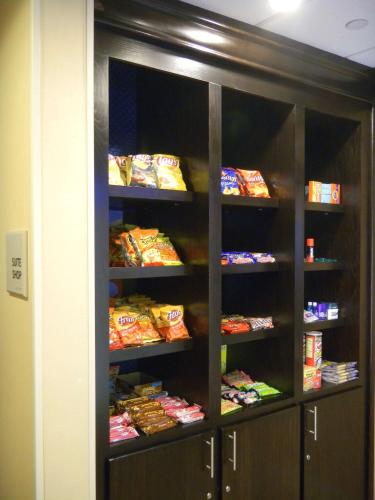 a cabinet filled with lots of bags of food at Hampton Inn Orange in Orange