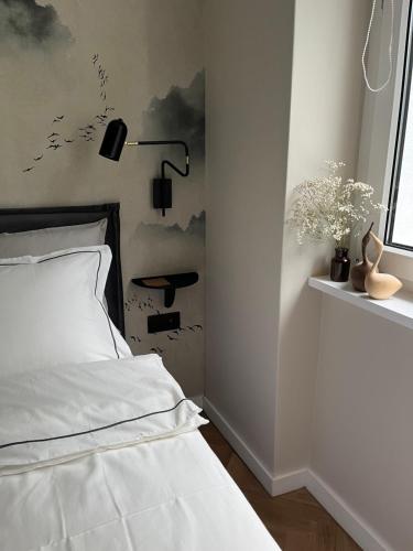 a bedroom with a white bed and a window at Luna Apartment in Warsaw