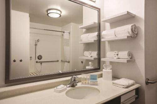 a bathroom with a sink and a shower and a mirror at Hampton Inn Brigham City in Brigham City