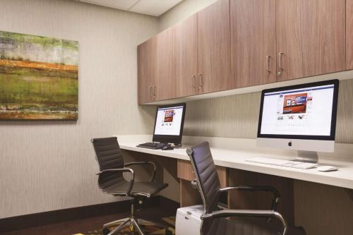 a room with two desks with two monitors and chairs at Hampton Inn Brigham City in Brigham City