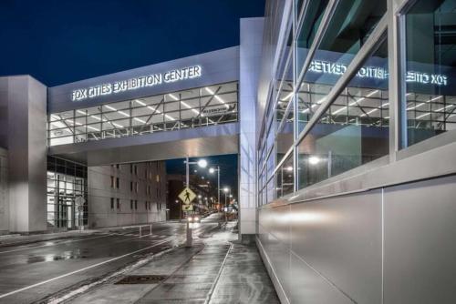 a night view of a building with a parking garage at Hilton Appleton Paper Valley in Appleton