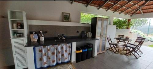 a kitchen with a counter and a table and chairs at Quinta Sol II Sea in Camacha