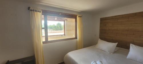 a bedroom with a bed and a window at Hotel Villa Javier VDL in Villa de Leyva