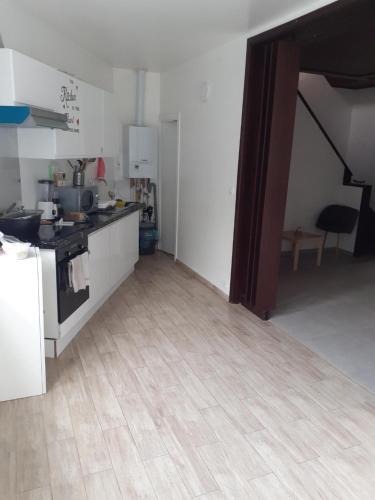 a kitchen with a wooden floor in a room at Room Marci- SweetHome in Marcinelle